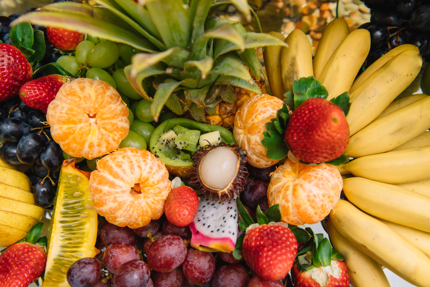 Fresh organic fruits background. Healthy eating concept. Fresh, exotic, organic fruits, light snacks in a plate on a buffet table
